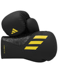 Pair of black Adidas x Anderson Silva Tilt150 boxing gloves, 16 oz size.