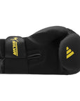 Adidas x Anderson Silva black boxing glove with yellow logo, 14 oz size.