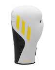 White boxing glove with yellow stripes, side view from Adidas x Anderson Silva.