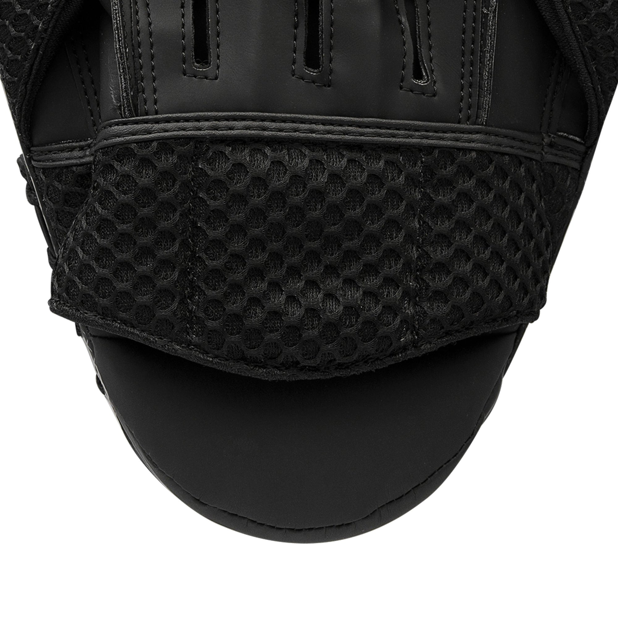 Close-up of Adidas boxing glove in black with yellow detail.