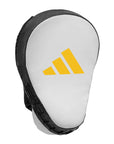 White and black glove with yellow Adidas logo for boxing training.