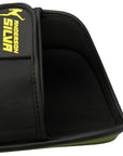 Black glove with a yellow logo on a shin protector.