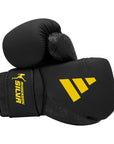 Black boxing glove with yellow logo, Adidas x Anderson Silva.