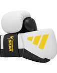 Pair of Adidas x Anderson Silva boxing gloves in white and yellow.