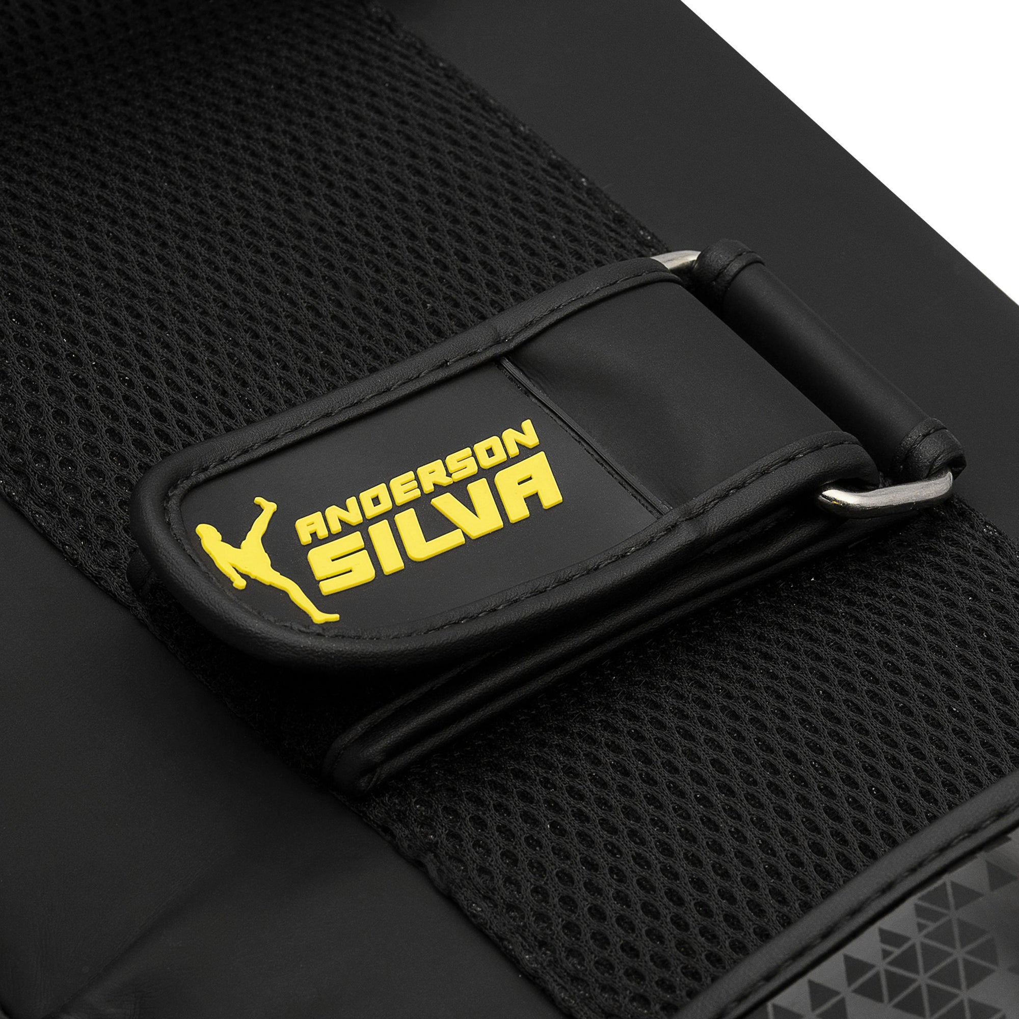 Black and yellow strap with yellow text on Adidas x Anderson Silva thigh pad.