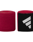 Red and black hand wraps designed for boxing.