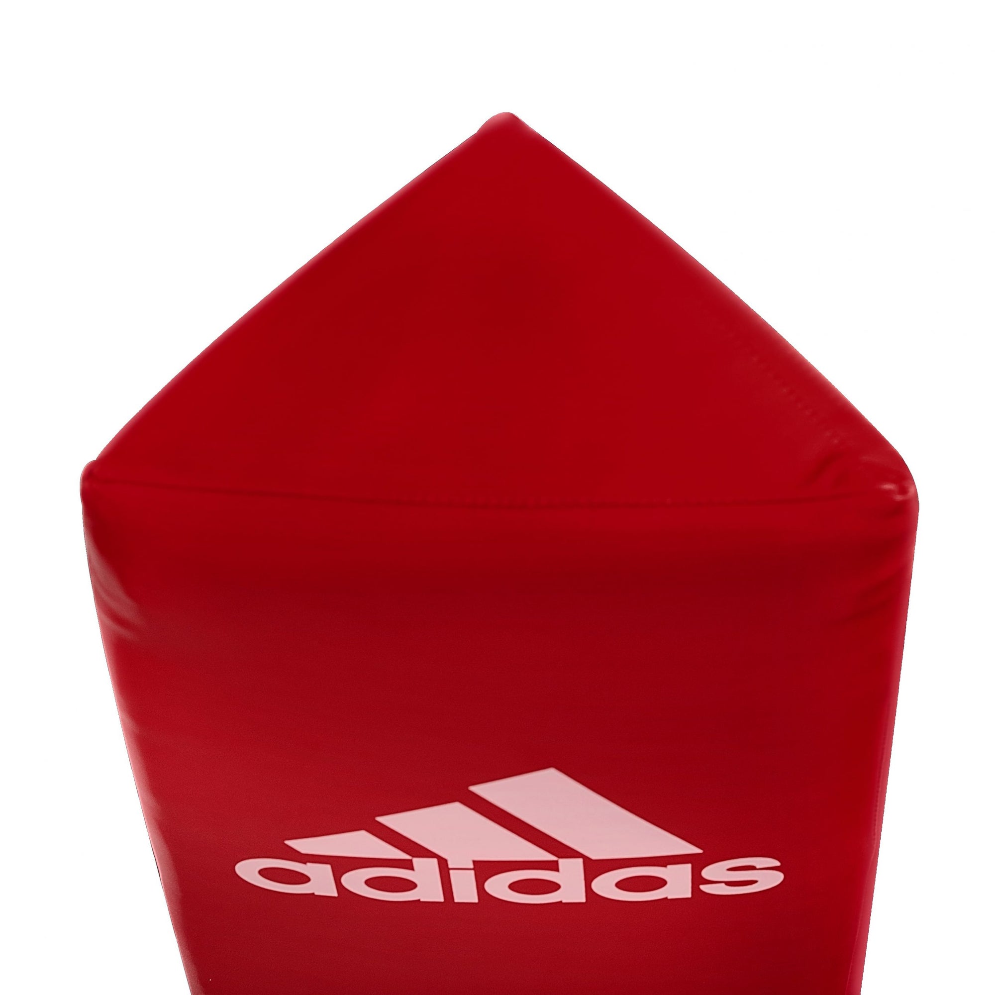 Red adidas corner pad with white text, close-up.