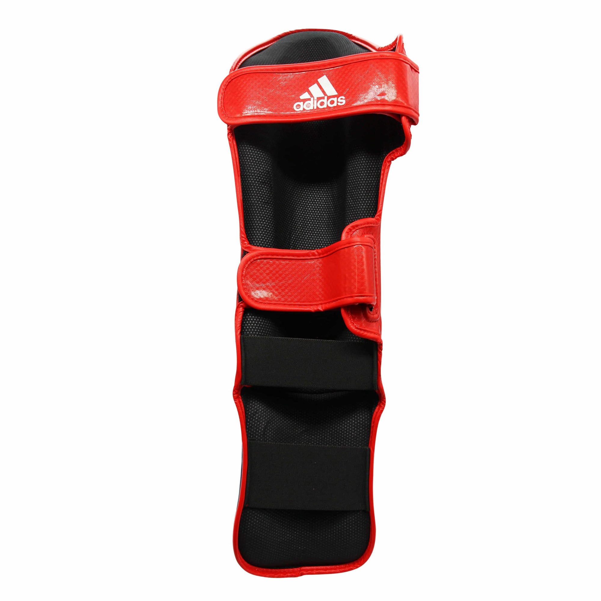 A red and black leg guard, part of the adidas Super Pro Shin N Step Protector.