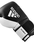 Single adidas Hybrid 150 boxing glove in black and white, 14 oz weight.