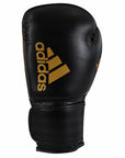 Black boxing glove with gold adidas logo.