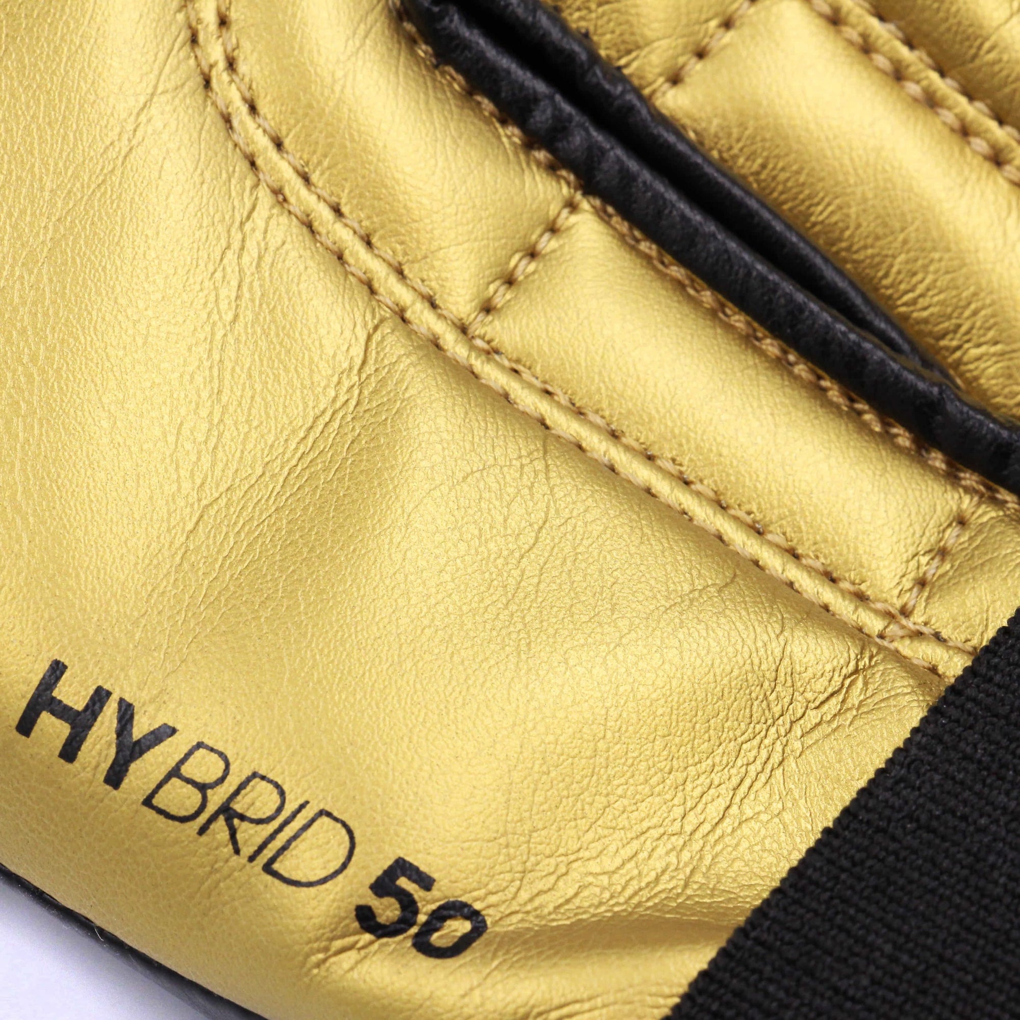 Close-up of black and gold boxing glove, adidas Hybrid 50.