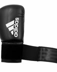 Black adidas boxing glove featuring white logo.