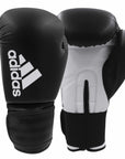 Pair of adidas Hybrid 50 boxing gloves in black and white.