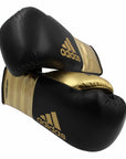 Pair of adidas Adi-Power Hybrid 500 Pro Boxing Gloves in black and gold.