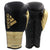 Pair of adidas Adi-Power Hybrid 500 Pro Boxing Gloves in black and gold.