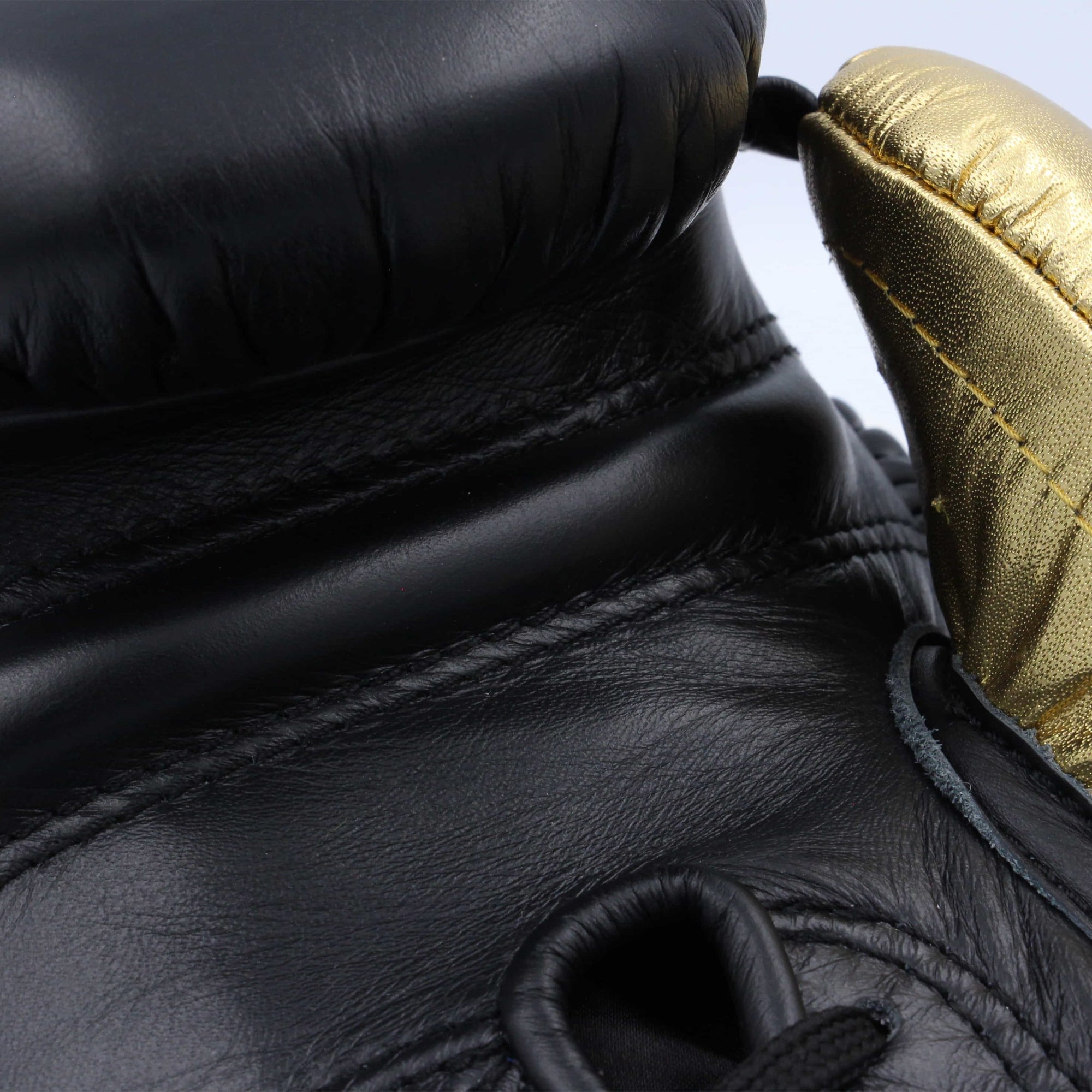 Close up of adidas Adi-Power Hybrid 500 Pro Boxing Glove in black and gold.