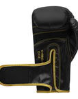 Black and gold boxing glove suitable for training sessions.