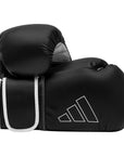 Black boxing glove with white trim by Adidas.