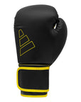 Black and yellow Adidas Hybrid 80 boxing glove.