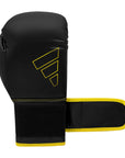 Adidas Hybrid 80 black and yellow boxing glove.