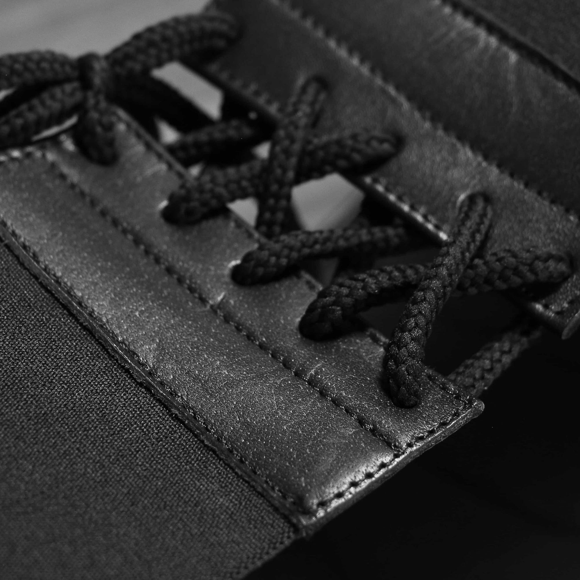 Close-up of a black and white shoelace on a boxing groin protector.