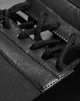 Close-up of a black and white shoelace on a boxing groin protector.