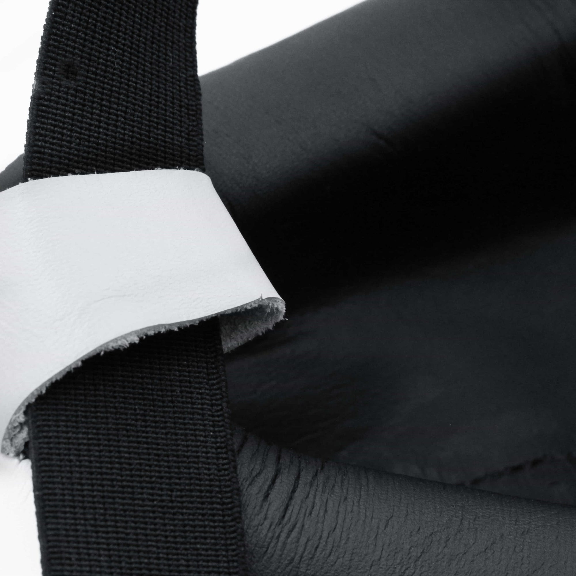 Close-up of a black bag featured in boxing protective gear.