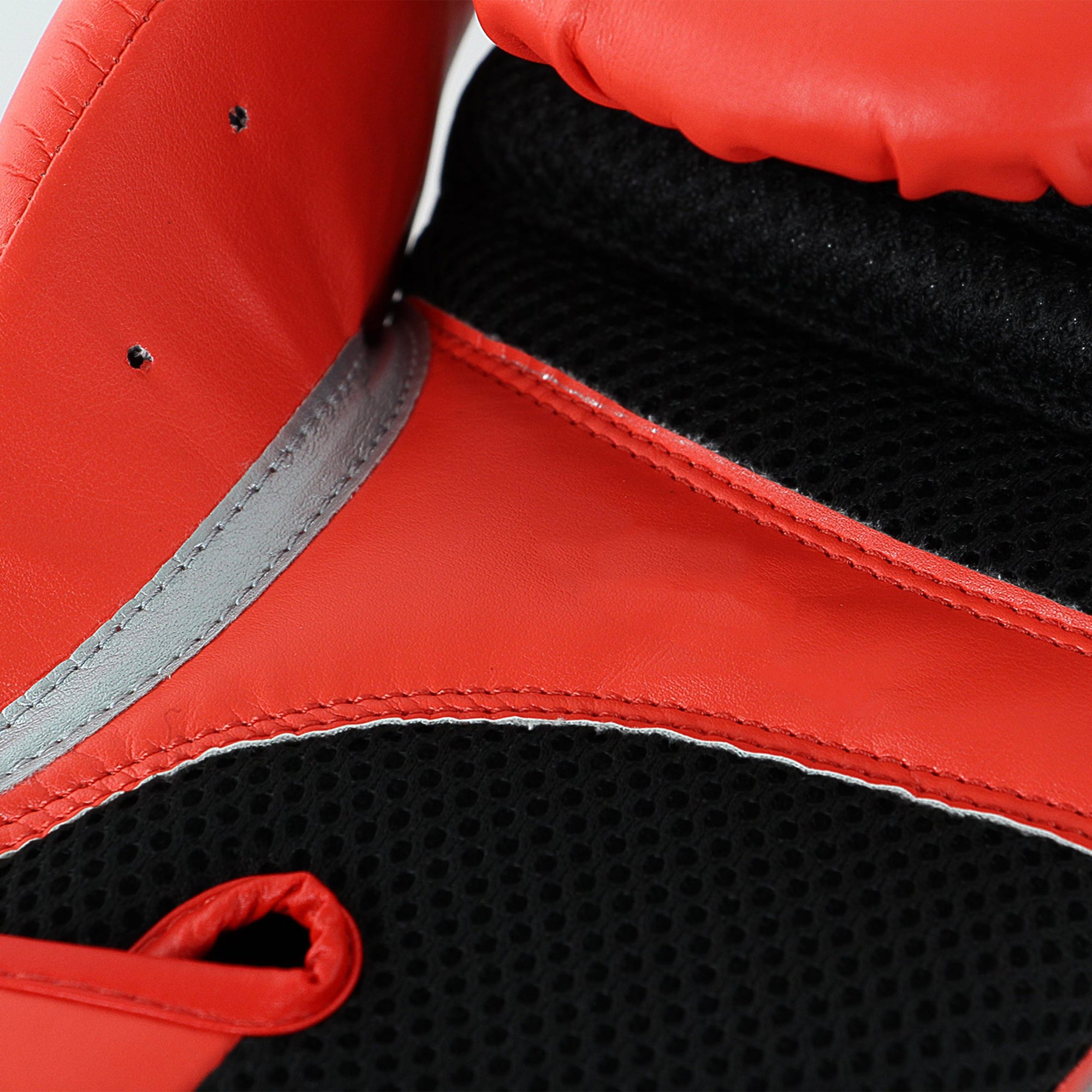 Close-up of a boxing glove, Adidas Speed 100 in solar red, 16 oz weight.