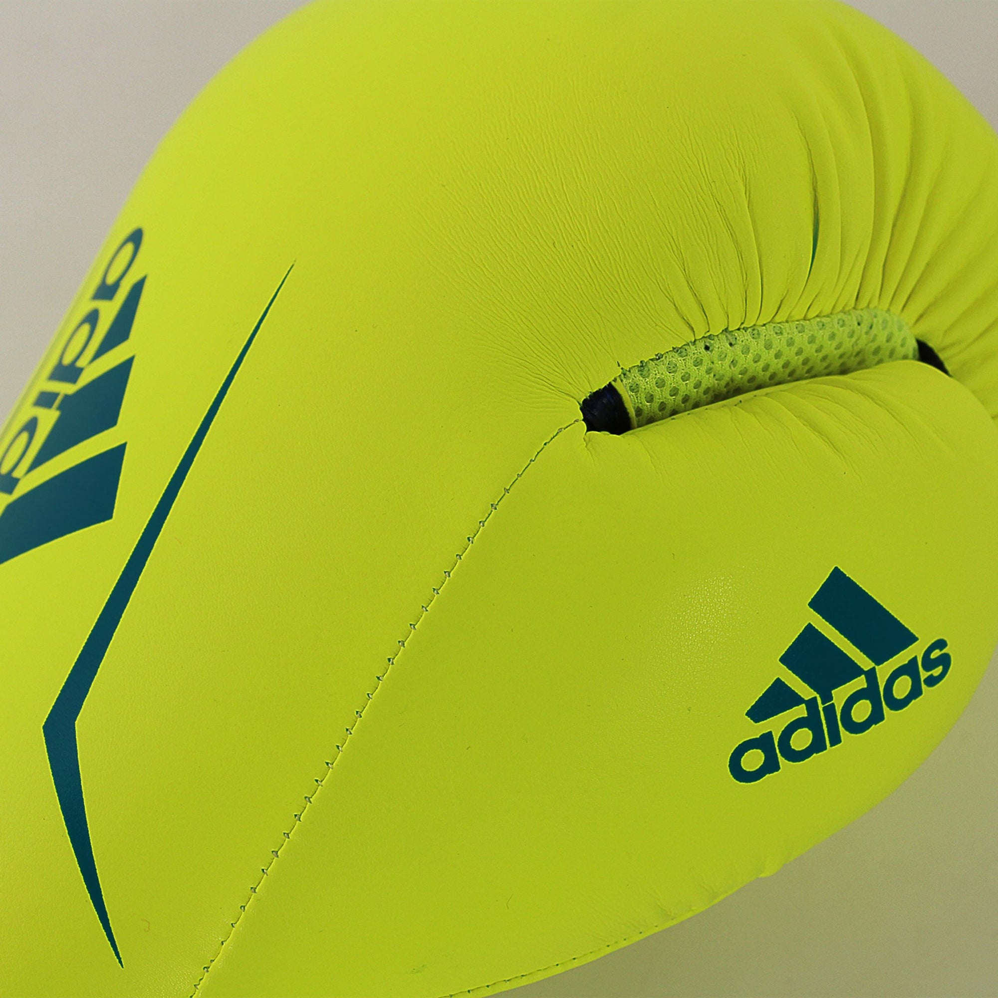 Yellow boxing glove with blue adidas logos.