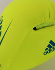 Yellow boxing glove with blue adidas logos.