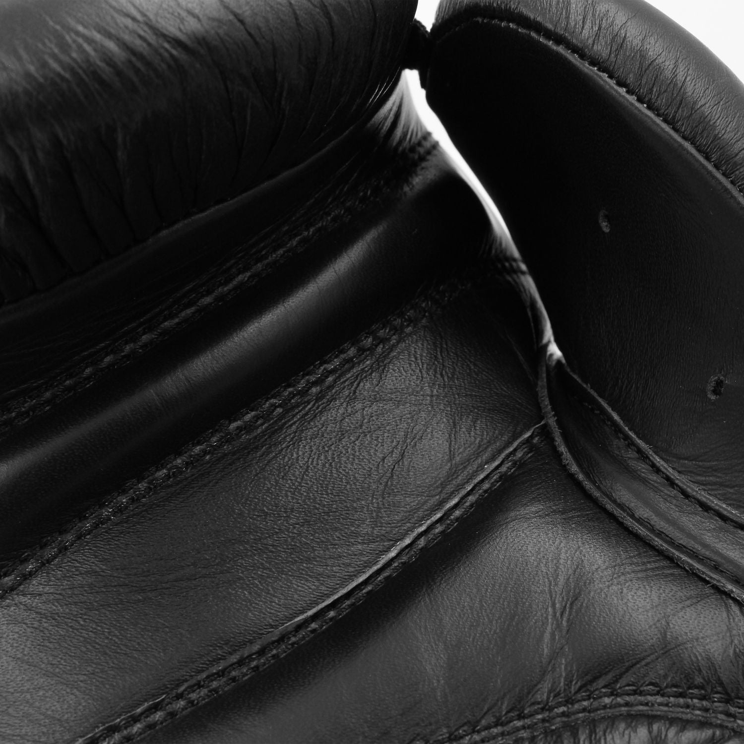 Close-up of a black boxing glove, showing design details.