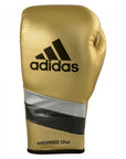 Gold boxing glove with black and silver stripes, adidas Adi-Speed 500.