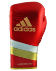 Red boxing glove with gold stripes, adidas Adi-Speed 500 Pro.