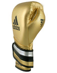 Gold Adidas boxing glove featuring black stripes.