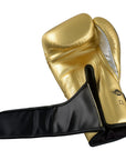 Gold boxing glove with black cover for boxing or kickboxing.