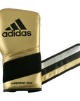 Gold boxing glove with black stripes for boxing or kickboxing.