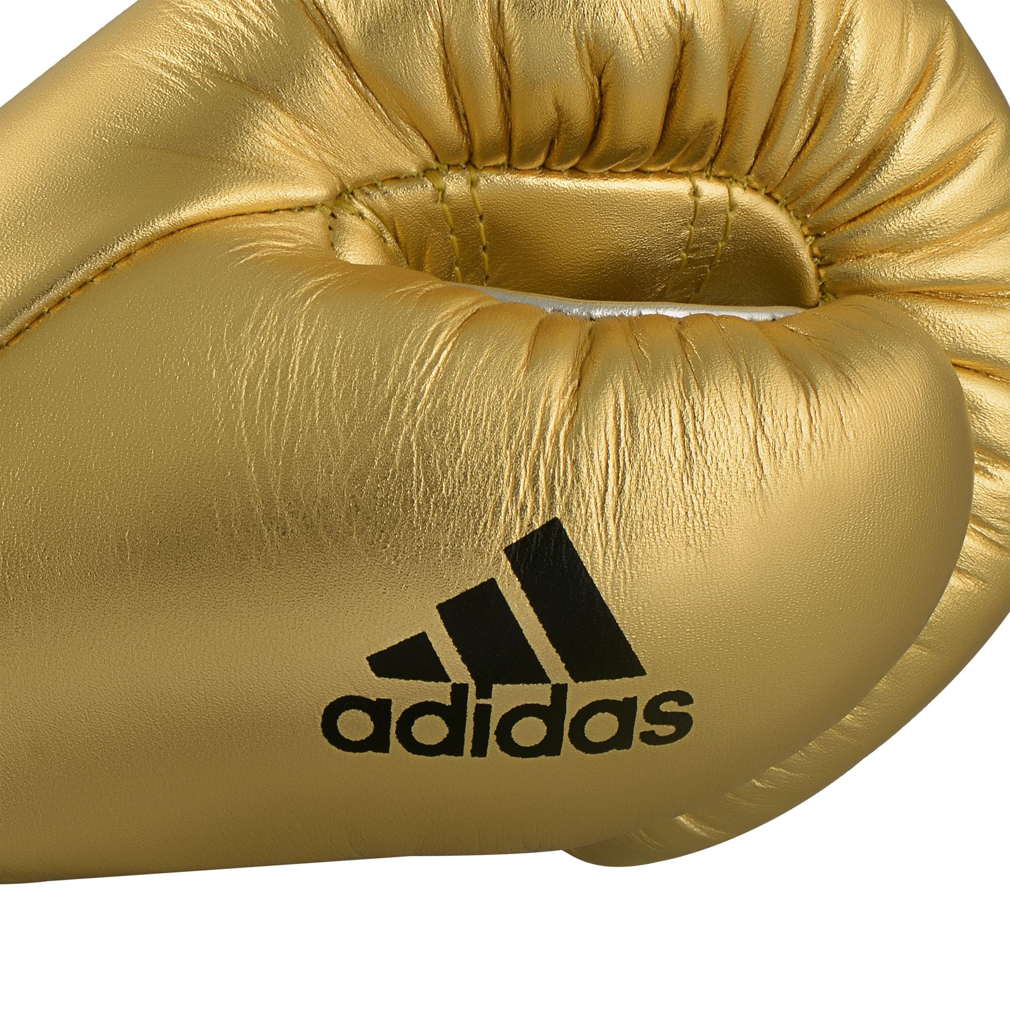 Close-up of gold Adidas boxing glove with logo detail.