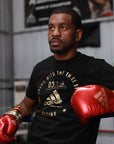 A man wearing red, gold, silver adidas boxing gloves.