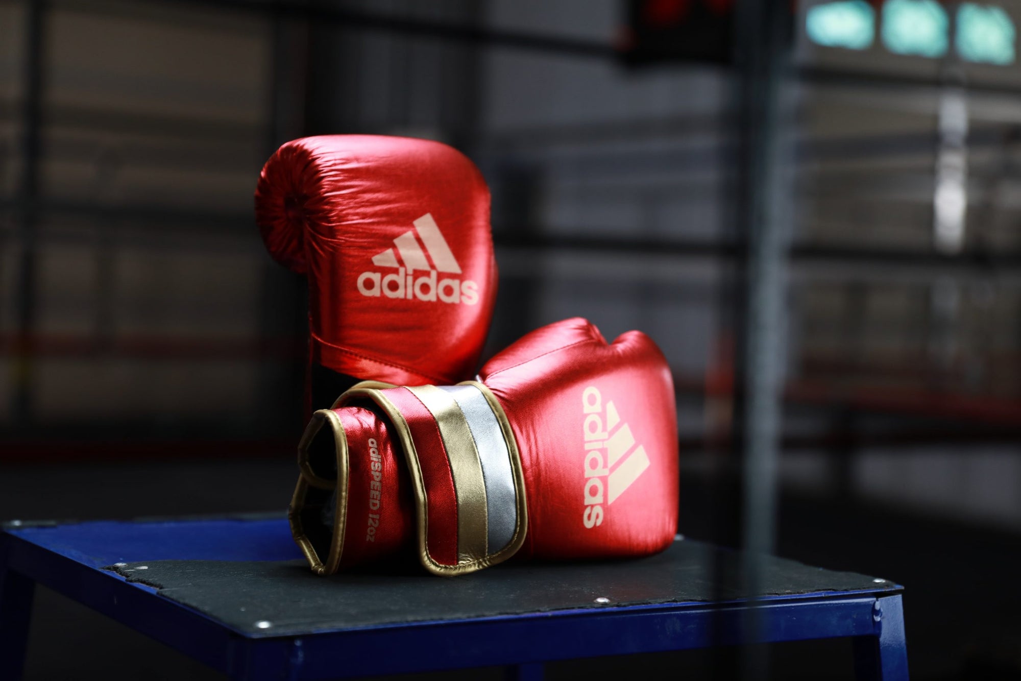 Pair of boxing gloves on a table, adidas Adi-Speed 501 series.