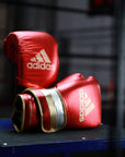 Pair of boxing gloves on a table, adidas Adi-Speed 501 series.