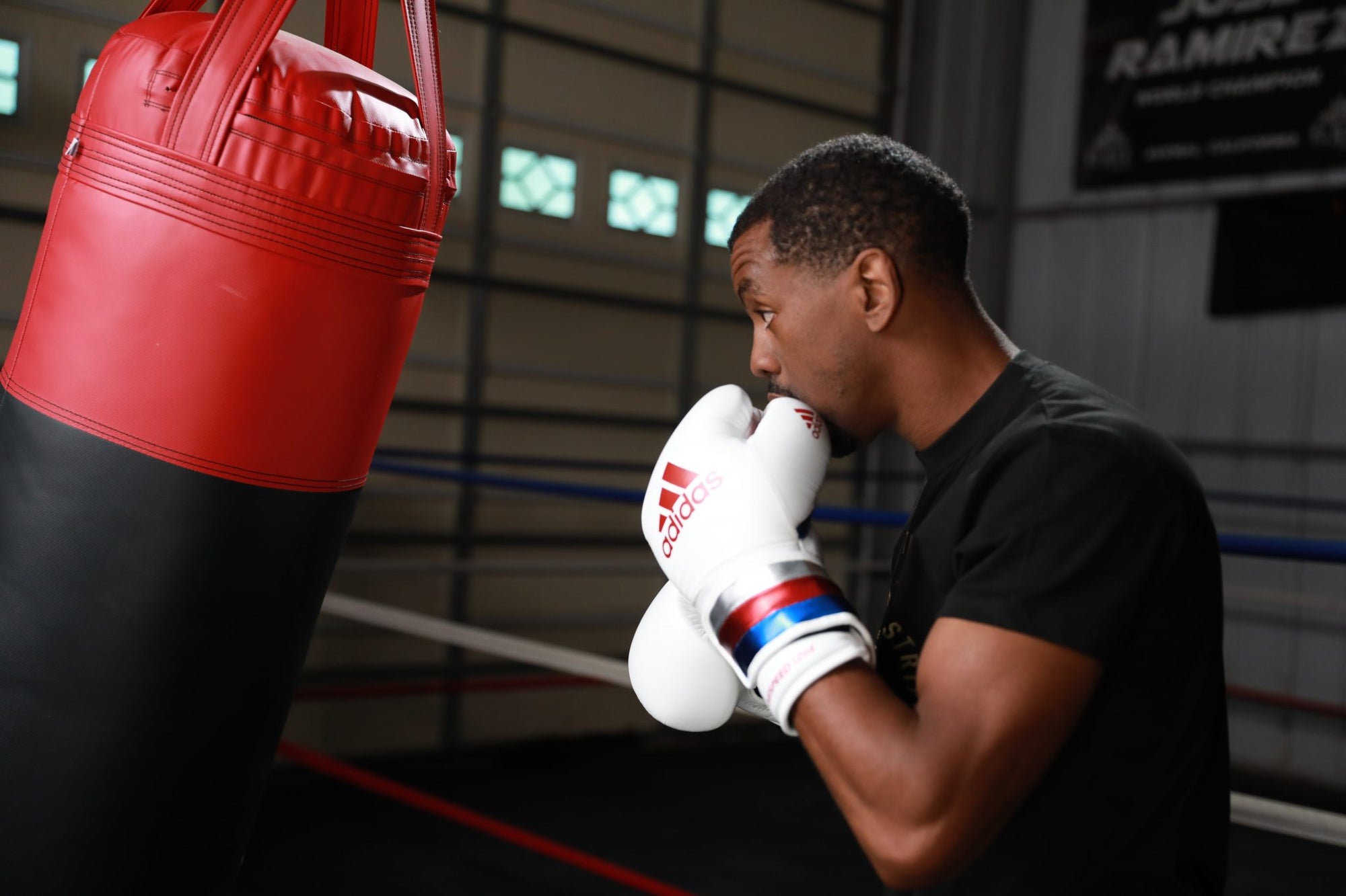 Man wearing boxing gloves during training.