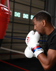 Man wearing boxing gloves during training.