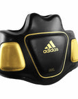 Black and gold Adidas boxing pad used for coaching.