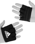 Pair of hands with black boxing gloves for knuckle protection.