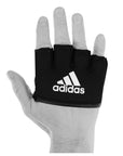 Hand wearing black adidas boxing knuckle protection glove.