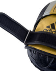 Close up of an Adidas black and gold boxing glove.