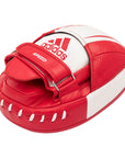 Red and white boxing glove by Adidas for training.