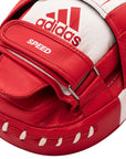 Close-up of red and white boxing glove by Adidas.