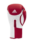 Single red and white boxing glove for training.