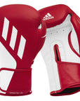 Pair of red and white boxing gloves for training.